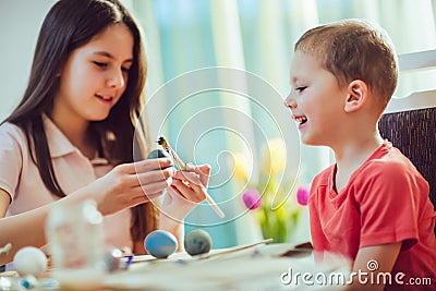 Children painted Easter eggs at the table Stock Photo