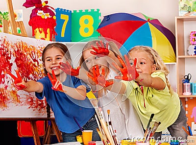 Children painting finger on easel. Small students in art school class. Stock Photo