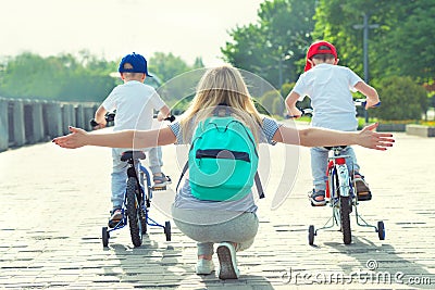 Children participate in competitions riding a bicycle. Family holiday on the promenade. Stock Photo