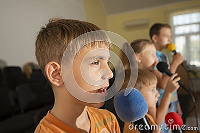 Children participate with a microphone, recite poems, recitation, sing songs Stock Photo