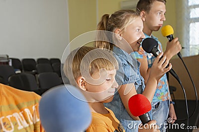 Children participate with a microphone, recite poems, recitation, sing songs Stock Photo