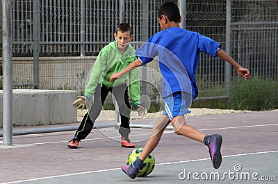 Children play football in the schoolyard Editorial Stock Photo
