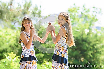 Children play in the frogs walking in the city park, and looked into the frame Stock Photo