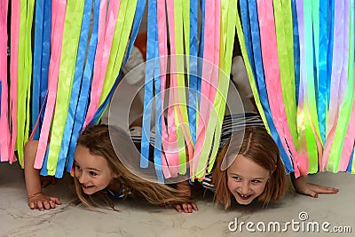 Children play a game crawl under the tape Stock Photo