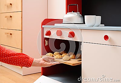 Children play in kitchen. Baking homemade cookies in toy oven Stock Photo