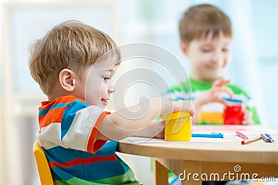 Children play and paint at home or kindergarten or playschool Stock Photo