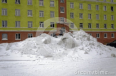 Children play on a snow slide in the polar city of Norilsk Editorial Stock Photo