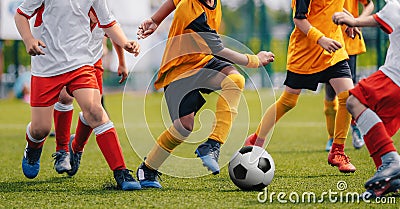 Children Play Soccer Game. Young Boys Running and Kicking Football Ball on Grass Sports Field Stock Photo