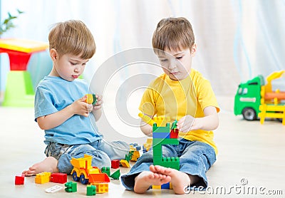 Children play toys on floor at home Stock Photo