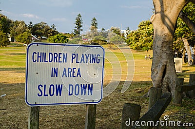`Children playing in area slow down` for warning drive slowly. Stock Photo