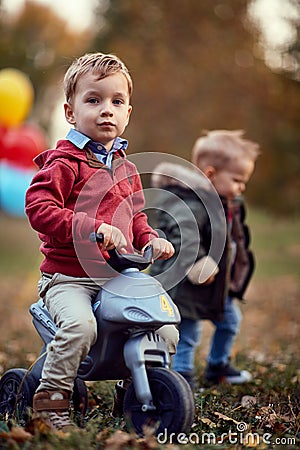 Children playing at the autumn park. Family, childhood, season and people concept Stock Photo