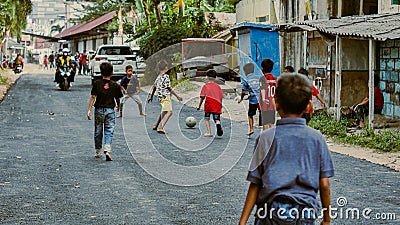 Children playing ball in the street Editorial Stock Photo