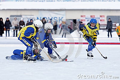 Children playing bandy on an outdoor stadium. Editorial Stock Photo