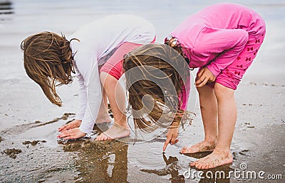 Children playing barefoot sandy beach of Atlantic ocean in Spain Stock Photo