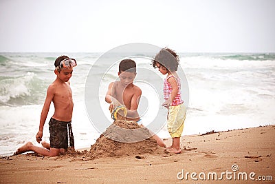Children playing on the beach Stock Photo