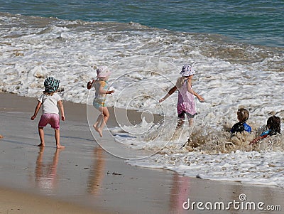 Children playing at the beach, happy days. Editorial Stock Photo