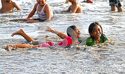 CHILDREN PLAYING AT THE BEACH IN INDONESIA Editorial Stock Photo