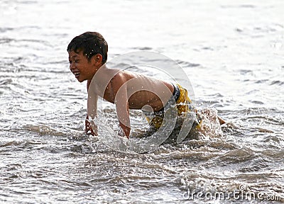 CHILDREN PLAYING AT THE BEACH IN INDONESIA Editorial Stock Photo