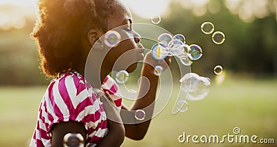 Children is playing bubbles in a park Stock Photo