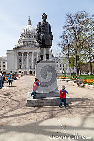 Children Playing by Capital Statue Editorial Stock Photo