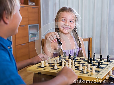 Children playing chess at home Stock Photo