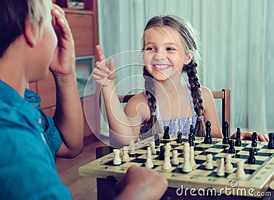Children playing chess at home Stock Photo