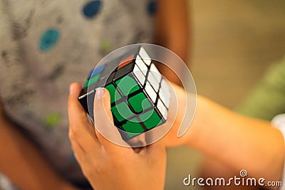 Children playing colorful rubik`s cube Editorial Stock Photo