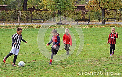 Children are playing football in city park Editorial Stock Photo