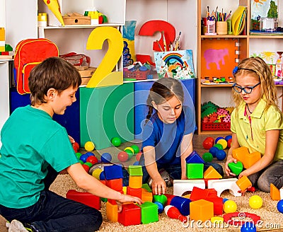 Children playing in kids cubes indoor. Lesson in primary school. Stock Photo