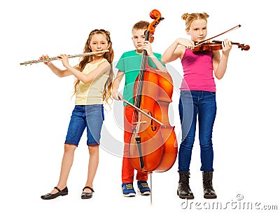 Children playing on musical instruments together Stock Photo