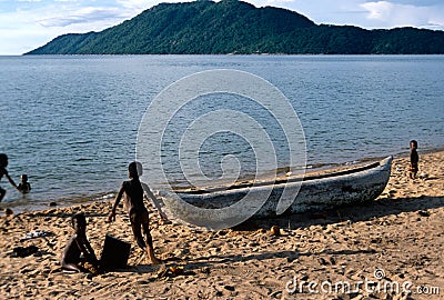 Children playing next to a pirogue, Lake Malawi. Editorial Stock Photo