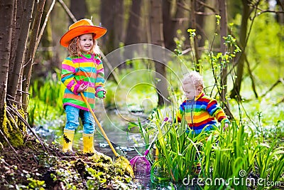 Children playing outdoors catching frog Stock Photo