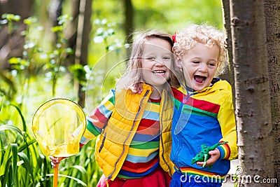 Children playing outdoors catching frog Stock Photo