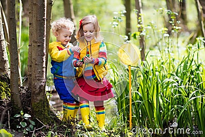 Children playing outdoors catching frog Stock Photo