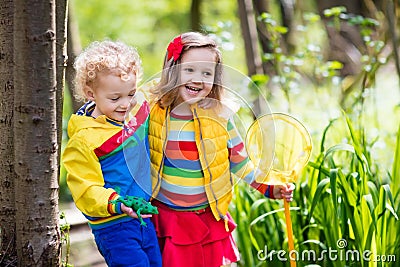 Children playing outdoors catching frog Stock Photo