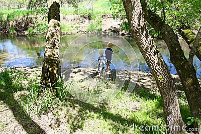 Children Playing Outside at the River Stock Photo