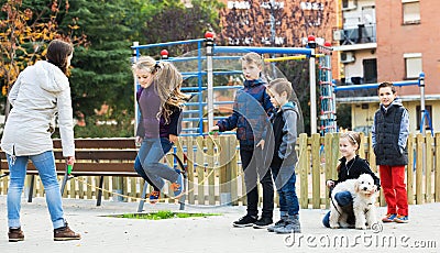 Children playing skipping rope Stock Photo