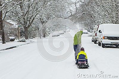 Children playing in the snow with a sled. Stock Photo