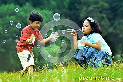 Children playing with soap bubbles Stock Photo