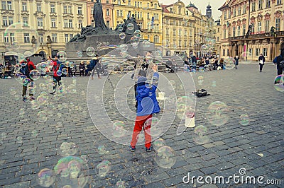 Children playing in Soap Bubbles in Prague Town Square Editorial Stock Photo