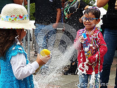 Children playing with spray foam on carnival, Cuenca Editorial Stock Photo