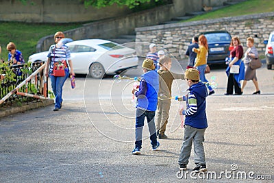 Children playing on the street with soap bubbles. Pyatigorsk, Russia Editorial Stock Photo