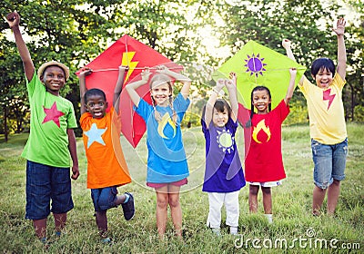 Children Playing Superhero With Kites Stock Photo