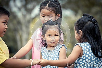 Children playing together in the park Stock Photo