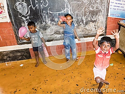 Children playing with toys balloon on the floor of the children`s room. Kindergarten educational games in India Editorial Stock Photo