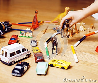 Children playing toys on floor at home, little hand in mess, free education Stock Photo