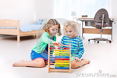 Kids playing with wooden abacus. Educational toy. Stock Photo