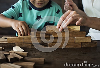 Children Playing Wooden Block Toy with Teacher Stock Photo