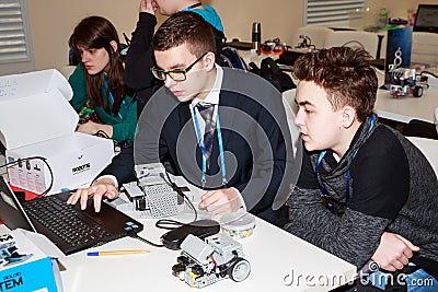 Children programming the robot at robotics competitions. Editorial Stock Photo