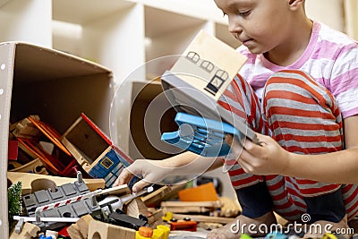 Children pull out wooden rails from a toy box. Educational toys for young children Stock Photo